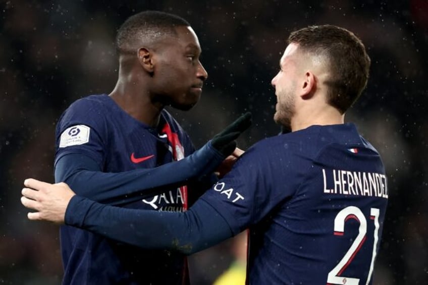 Paris Saint-Germain's Randal Kolo Muani (L) celebrates his winning goal