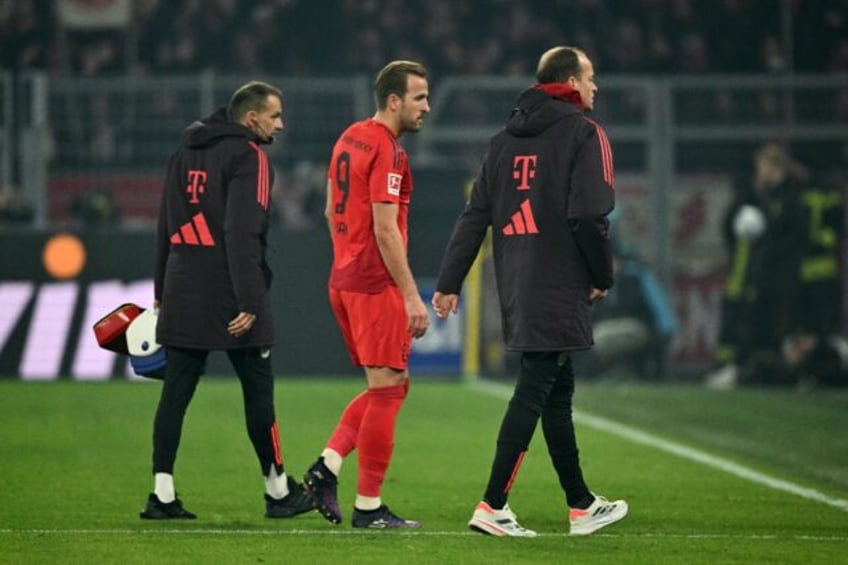 Bayern Munich's English forward Harry Kane (C) suffered a hamstring injury during Saturday