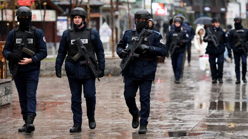 Kosovo Police officers patrol in the streets of Mitrovica, which is ethnically split between Serbs in the north and Albanians in the south, on Nov. 30, 2024.