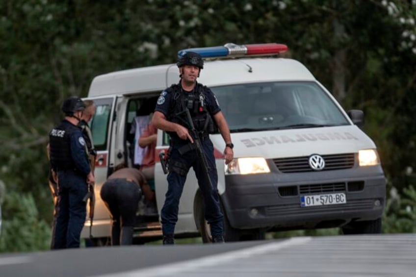 kosovo mourns a slain police officer some serb gunmen remain at large after a siege at a monastery