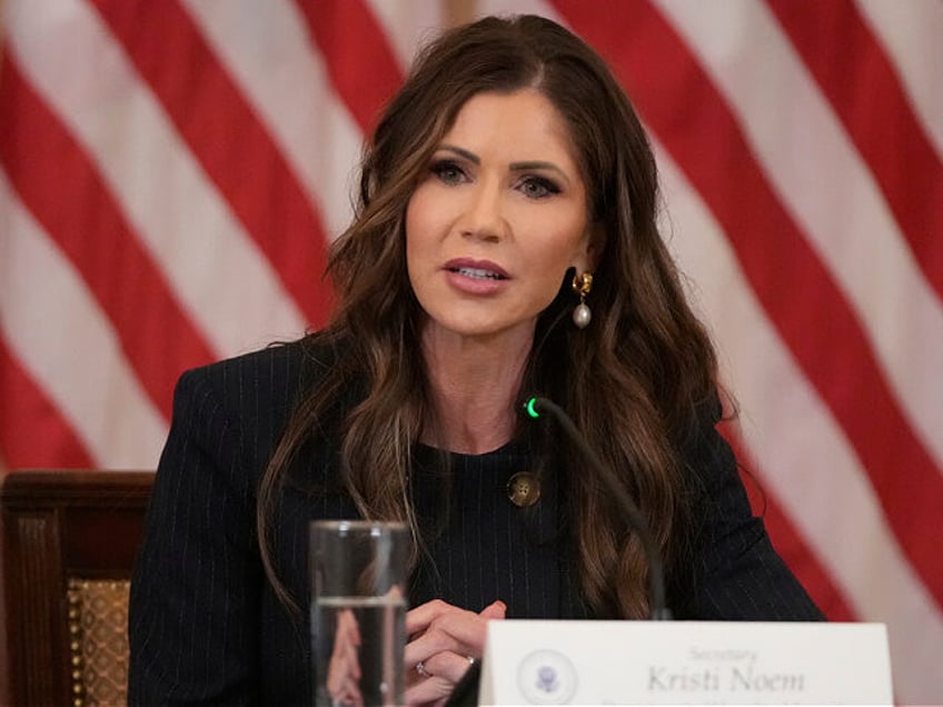 Homeland Security Secretary Kristi Noem listens as President Donald Trump speaks during a
