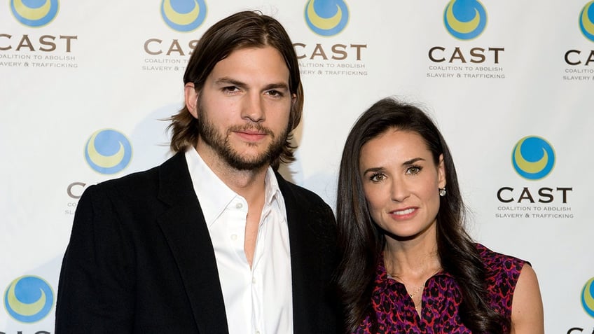 Ashton Kutcher and Demi Moore posing together