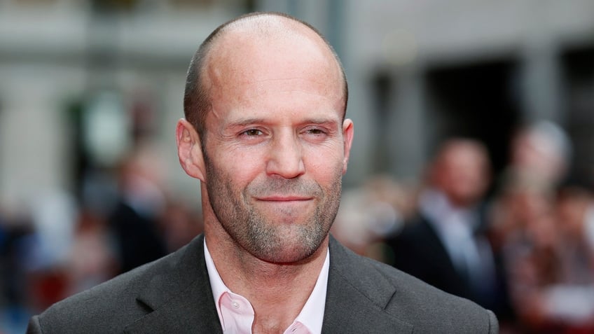 Actor Jason Statham poses for photographers as he arrives for the world premiere of "Hummingbird", at Leicester Square in central London June 17, 2013. REUTERS/Stefan Wermuth (BRITAIN - Tags: ENTERTAINMENT SOCIETY) - LM1E96H1F9401