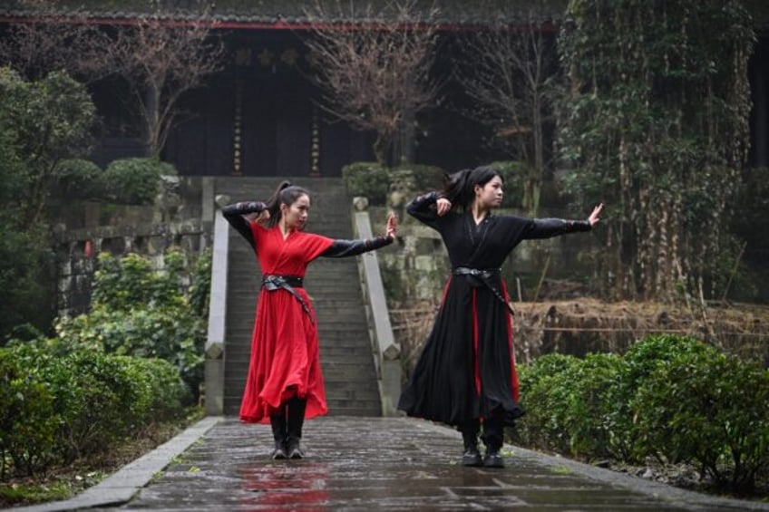 The all-woman Emei Kung Fu Girls troupe records slick videos of their skills, attracting r