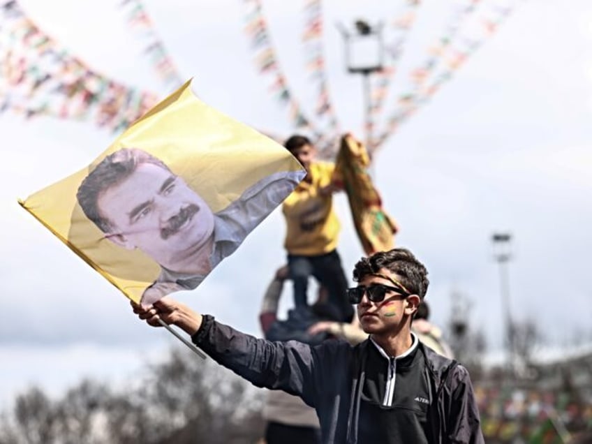 DIYARBAKIR, TURKEY - MARCH 21: A Kurdish youth holds a poster of jailed PKK militant group