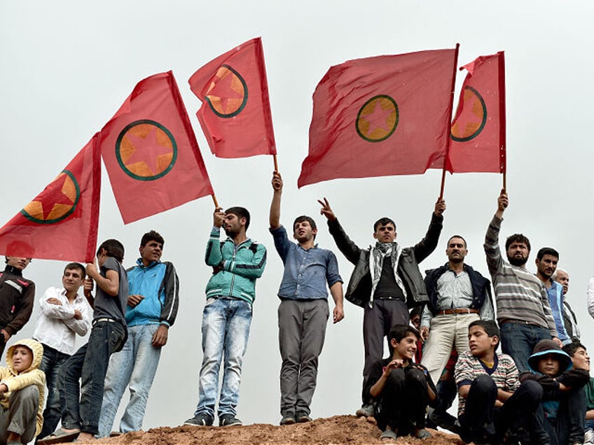 TOPSHOT - Kurdish people wave Kurdistan Workers' Party (PKK) flags while attending a funer