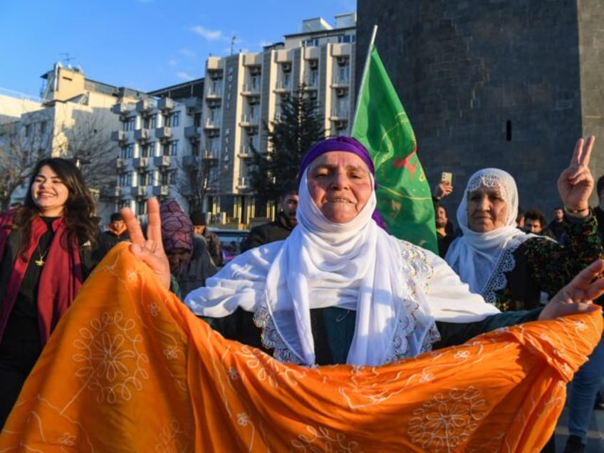 A supporter flashes a victory sign after jailed leader of the Kurdistan Workers' Party (PK