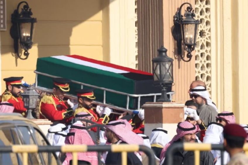 The coffin of Kuwait's late Emir Sheikh Nawaf al-Ahmad Al-Sabah is carried out of the Bilal bin Rabah Mosque in Kuwait City ahead of burial during his funeral