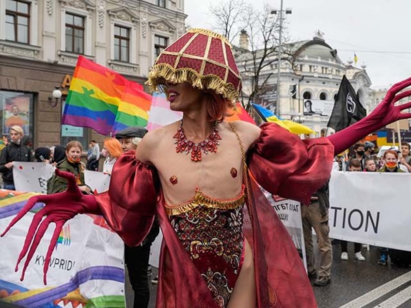 People take part in the annual Gay Pride parade, under the protection of riot police in Ky