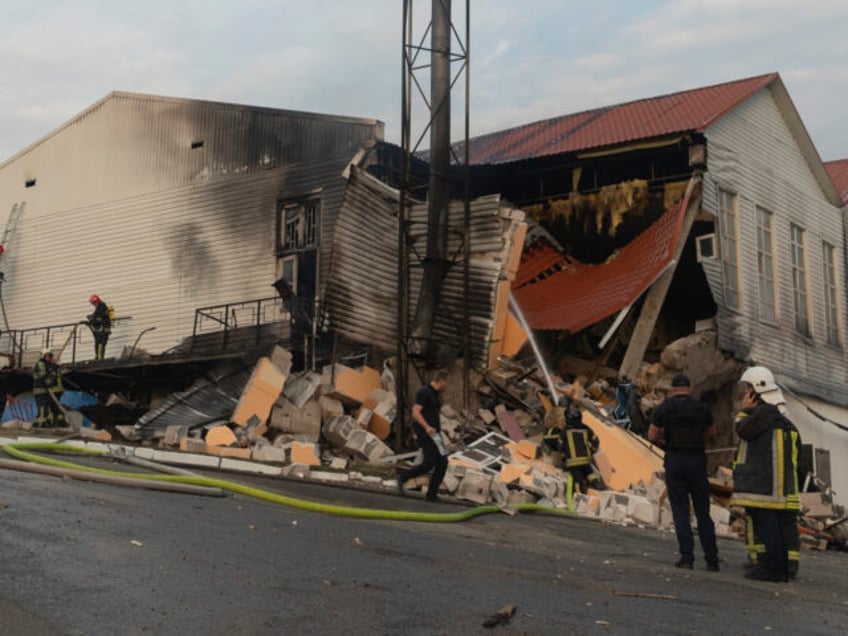 Firefighters extinguish a fire after a rocket hit a building of a higher education institu