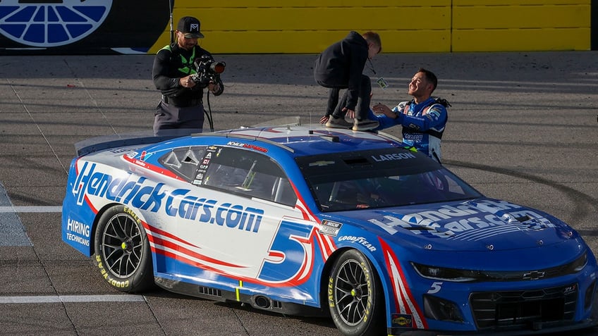 Kyle Larson with his son