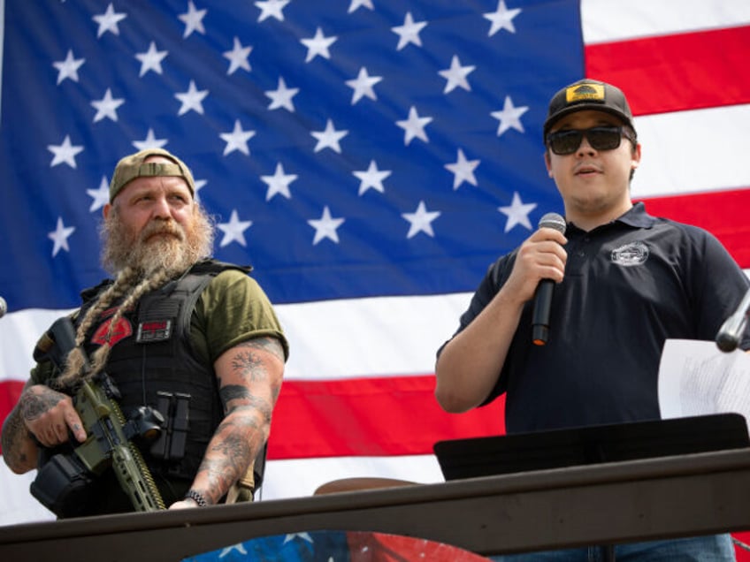 Kyle Rittenhouse (right), the then-17-year-old who, in 2020, shot and killed two protestor