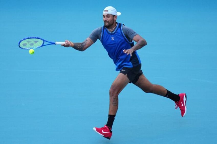 Nick Kyrgios returns a shot against Mackenzie McDonald en route to his first win since 202