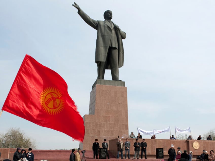 FILE - Protesters rally in front of a statue of Soviet Union founder Vladimir Lenin on a c