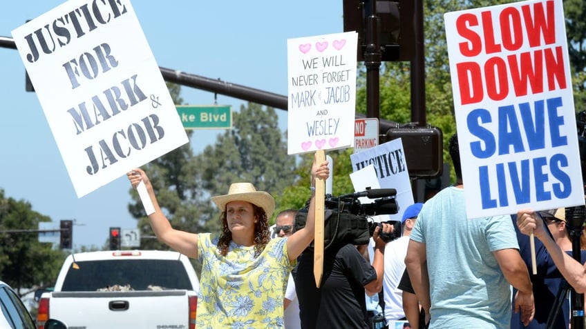 Protesters at the intersection where Mark and Jacob Iskander were killed urge drivers to slow down