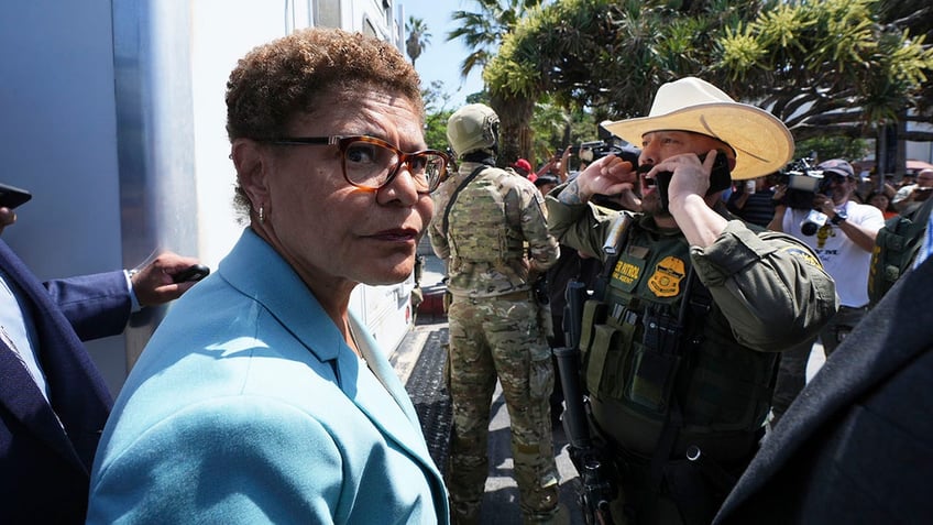 Los Angeles Mayor Karen Bass stands in front of a border patrol federal agent at MacArthur Park Monday, July 7, 2025, in Los Angeles.