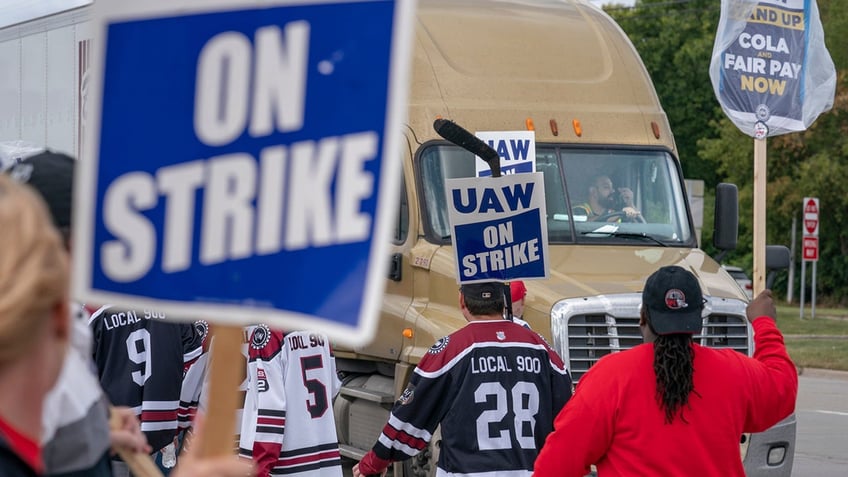 UAW Strikers slow a truck from entering the Ford Michigan Assembly Plant