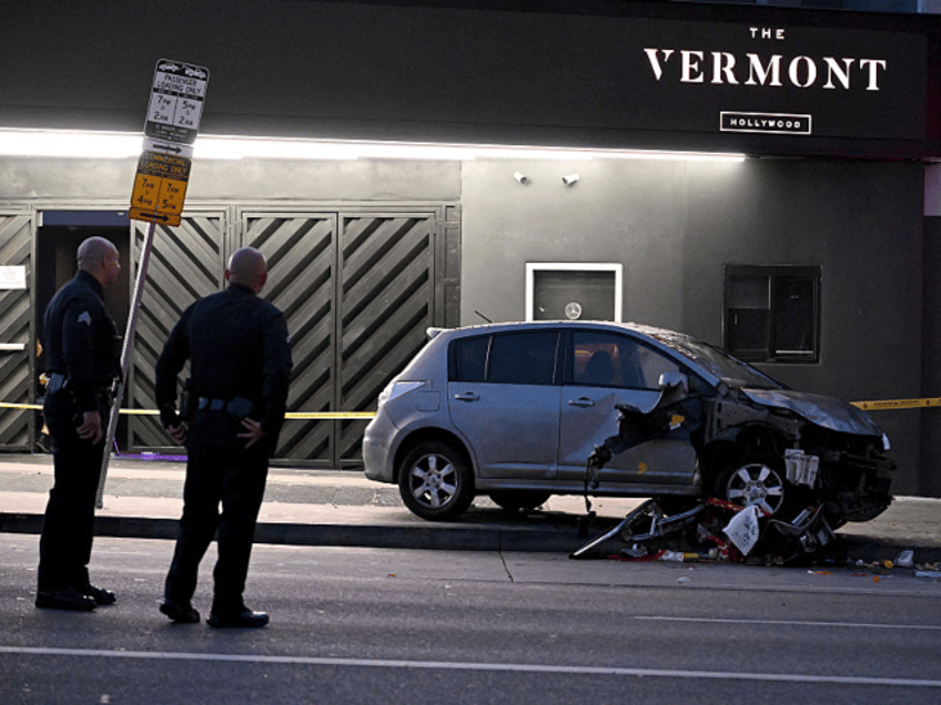 Officers stand at the scene of a crashed vehicle which drove into a crowd in Hollywood in