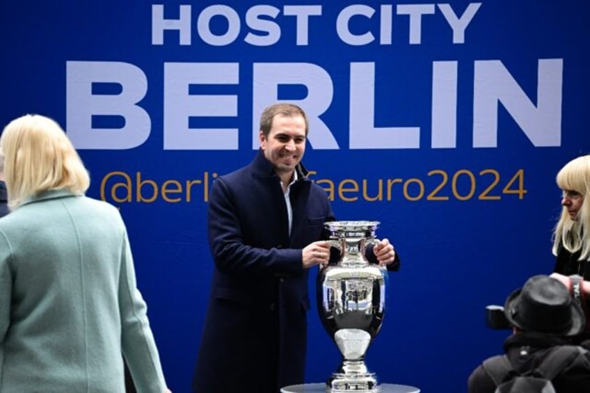 Euro 2024 tournament director Philipp Lahm poses with the trophy in Berlin