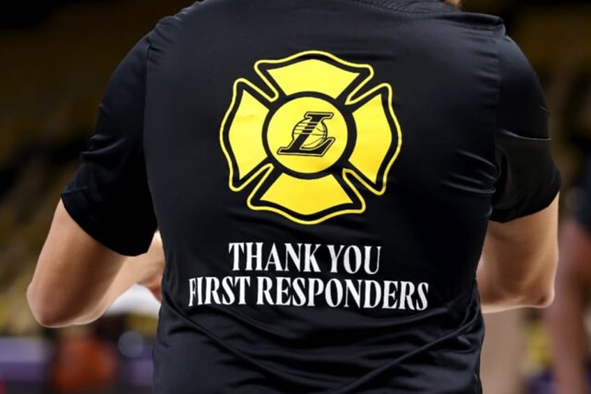 A member of the Los Angeles Lakers wears a shirt thanking first responders battling wildfi