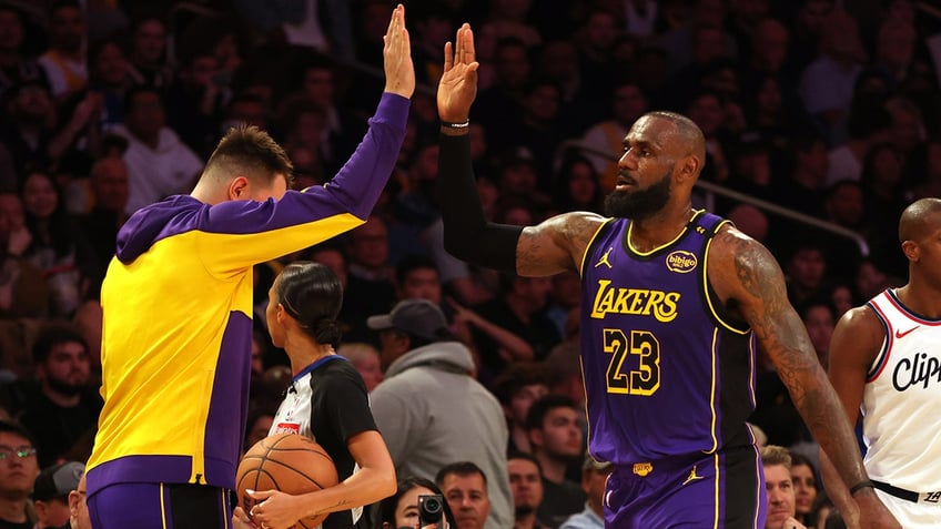 LeBron James celebrates with Luka Doncic