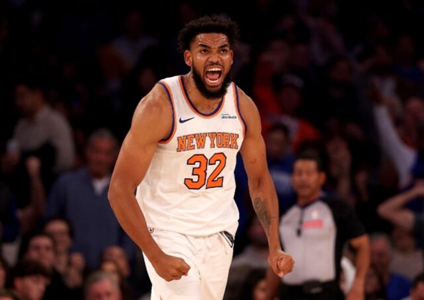 Karl-Anthony Towns of the New York Knicks reacts after a dunk in the first quarter of an N