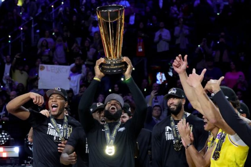 LeBron James celebrates with teammates after capturing the NBA Cup with a victory over the Indiana Pacers in the final of the league's first-ever in-season tournament