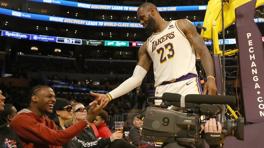 LeBron James and Bronny James share a handshake