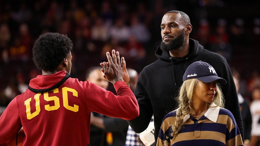 LeBron James and Bronny James high five