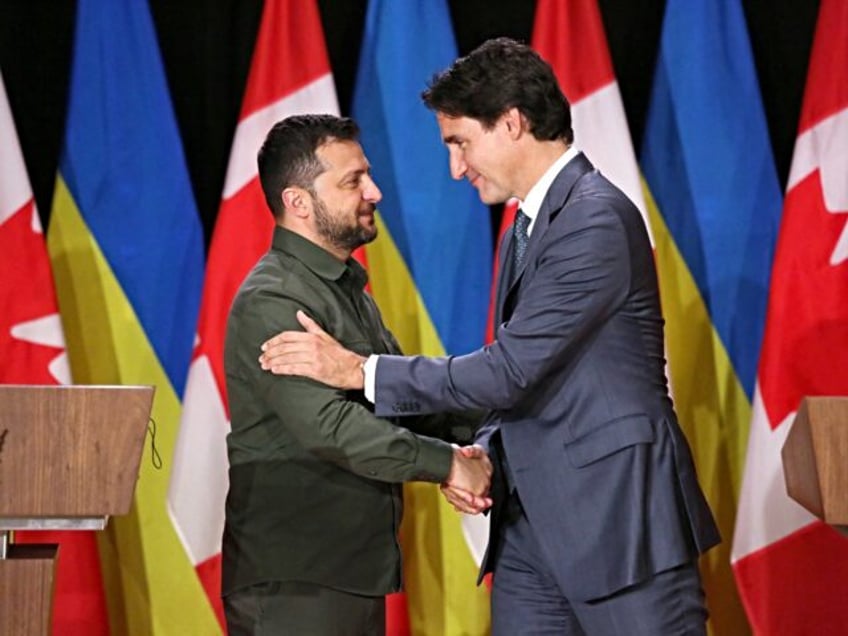 Canadian Prime Minister Justin Trudeau (R) and Ukraine's President Volodymyr Zelensky shak