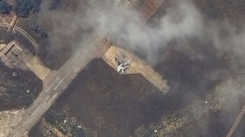 A damaged plane, likely a MiG 31 fighter aircraft, at Belbek air base, near Sevastopol, in Crimea