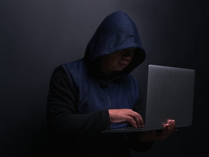hacker works on laptop