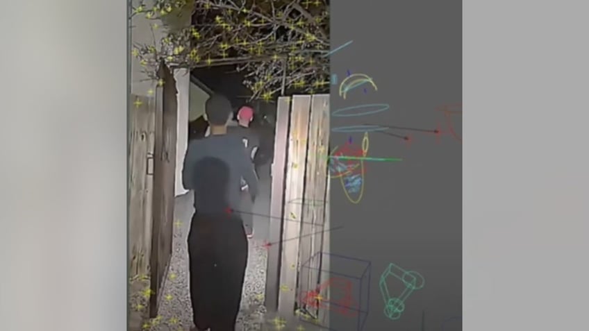Scott Roder demonstrated the potential movement of a blurry dark "anomaly" that he believes is an alien face peering over the fence.