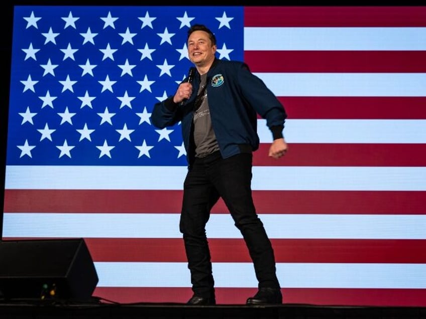 Elon Musk dances in front of the flag