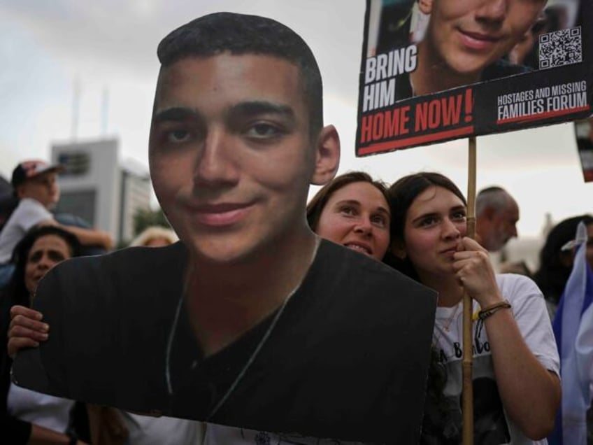 People watch a live broadcast of Israeli-American soldier Edan Alexander as he is released