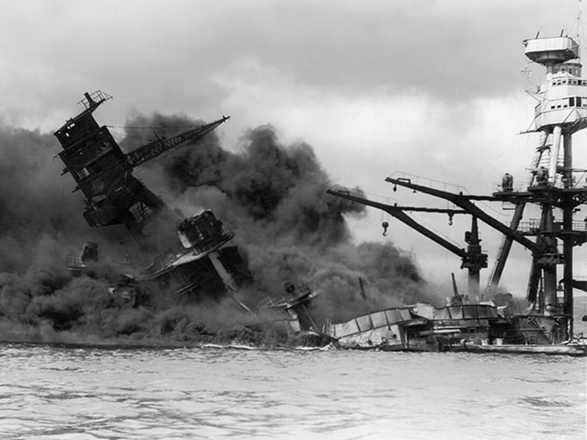 7th December 1941: The USS Arizona sinking in a cloud of smoke after the Japanese attack on Pearl Harbor during World War II, Hawaii. (Photo by Hulton Archive/Getty Images)