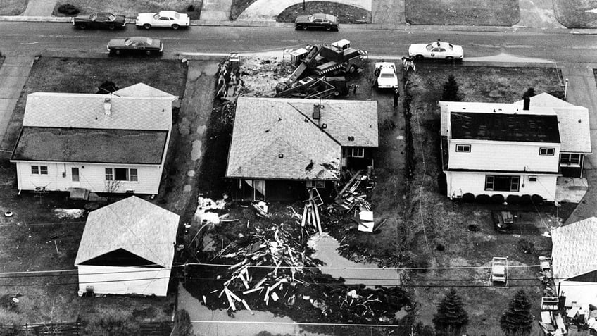 Black and white aerial shot of John Wayne Gacy's home torn up