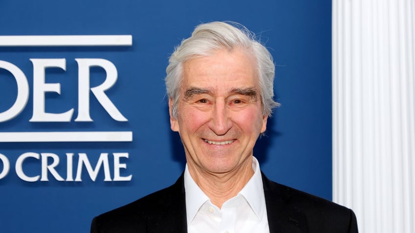 sam waterston smiling on red carpet