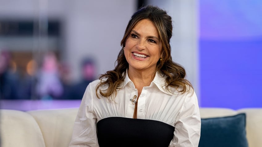 Mariska Hargitay smiling on a couch