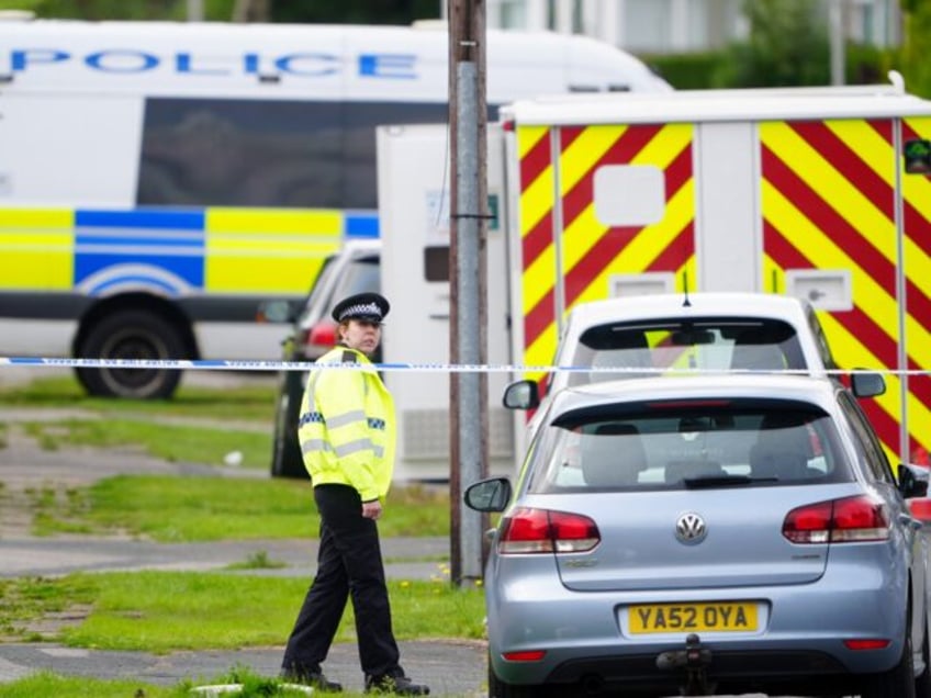 Emergency services in Westbury Road, Bradford, following a house fire where four people, i