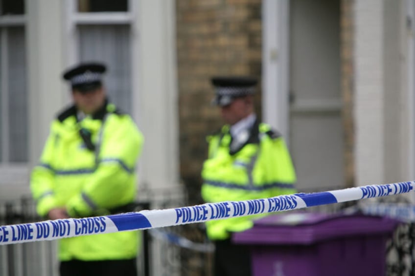 LIVERPOOL, UNITED KINGDOM - JULY 1: Police officers stand outside a house in Hatherley Str