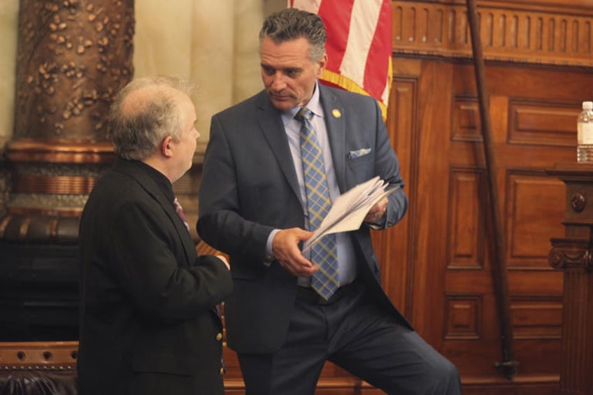 Kansas Senate President Ty Masterson, right, R-Andover, confers with his communications director Mike Pirner during a break in the Senate's session, Tuesday, April 30, 2024, at the Statehouse in Topeka, Kan. Lawmakers have adjourned their annual session without voting on a proposal to help the Kansas City Chiefs and Kansas City Royals finance new stadiums in Kansas. (AP Photo/John Hanna)