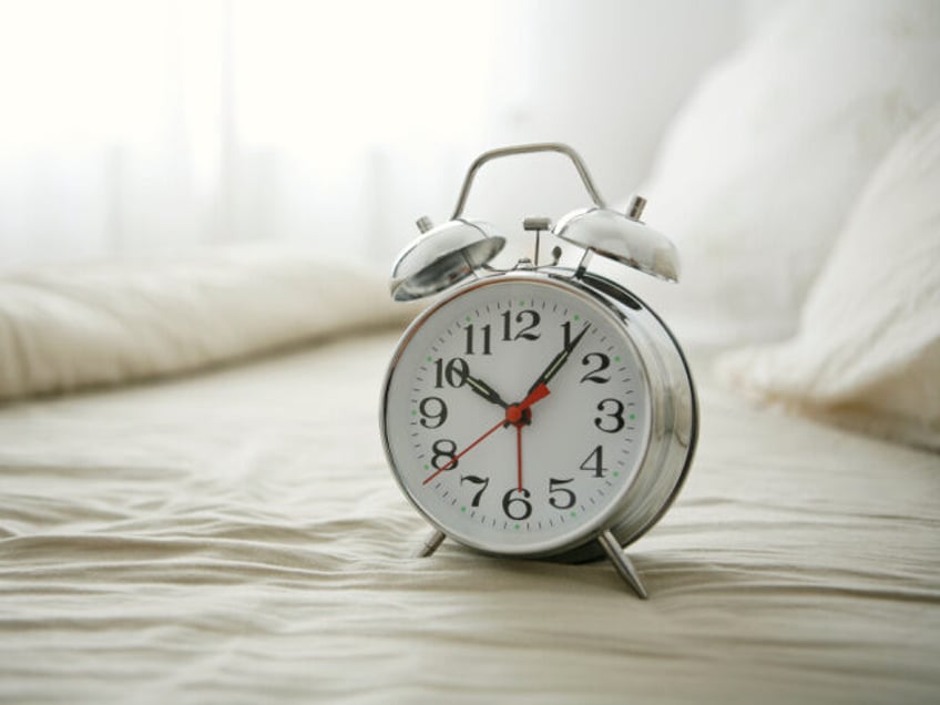 Alarm clock on a comfortable bed