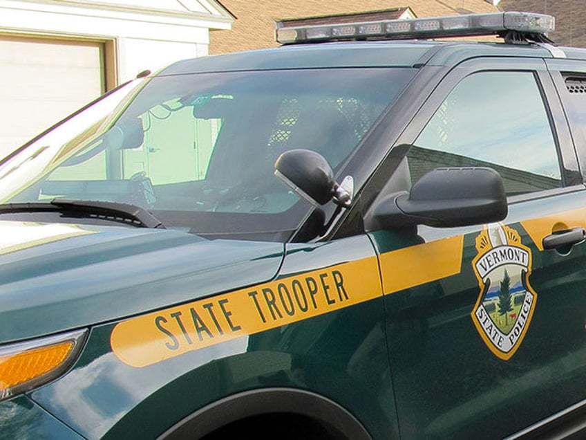 In this Wednesday Nov. 25, 2015 photo, Vermont State Police Trooper Richard Slusser, who regularly stops speeders traveling faster than 100 miles per hour, poses with his dog Drager beside his cruiser outside the state police barracks in Royalton, Vt. Slusser catches most of the excessive speeders in the southbound …