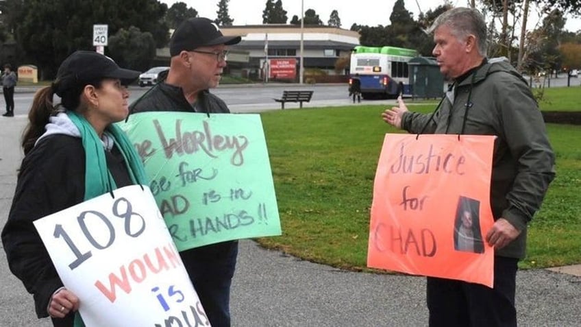 Sean O'Melia, right, chats with other protesters i