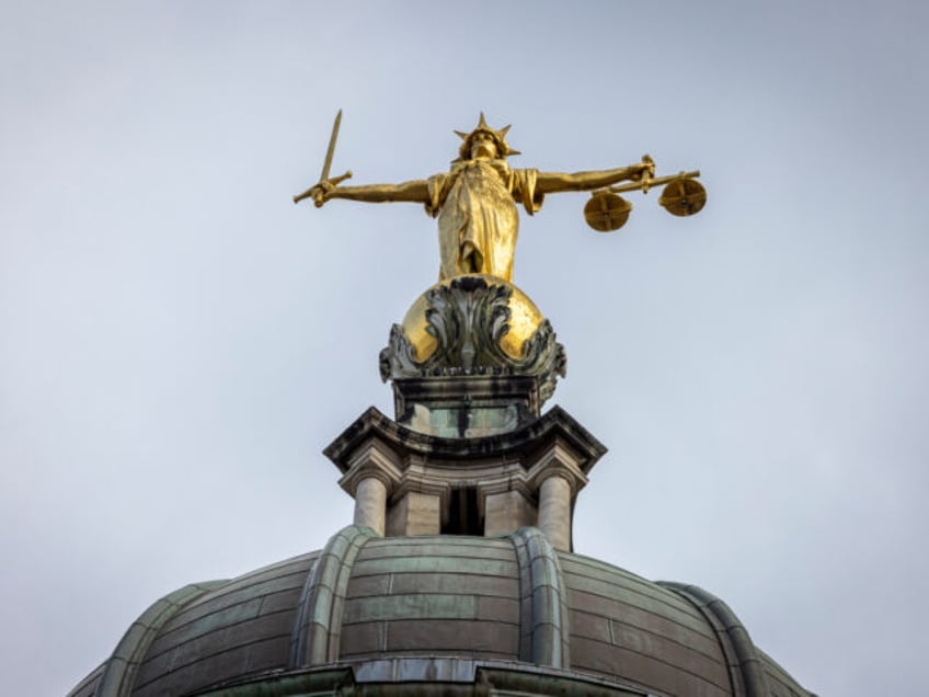 A gold statue of Lady Justice sits on top of the central criminal court on the 11th of Mar
