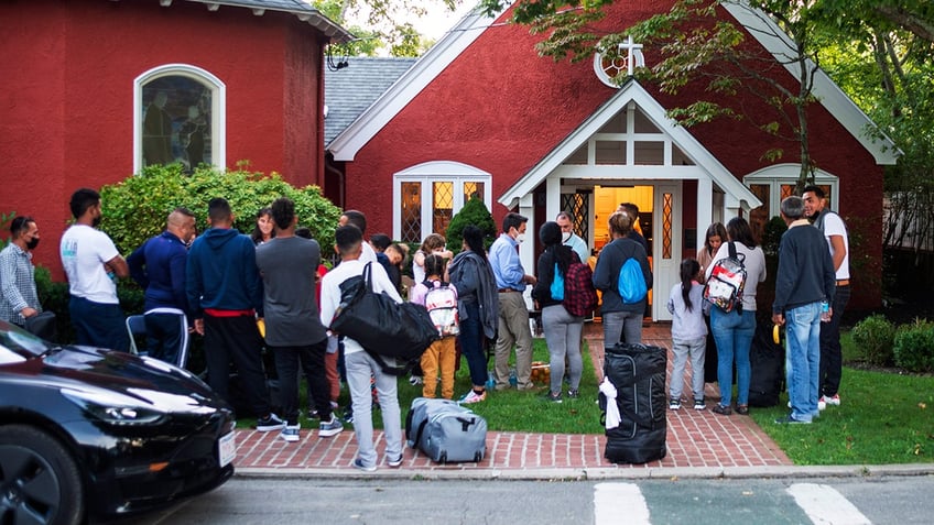 Migrants standing outside of a church