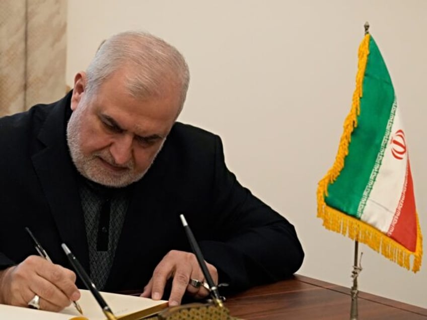 Mohammed Raad, the head of Hezbollah's parliamentary bloc, signs a condolences book to com