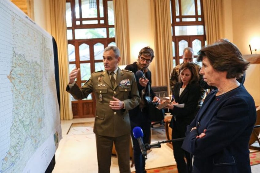 UNIFIL chief Aroldo Lazaro (L) shows a planning map of the Lebanon-Israel border area at a meeting with France's Foreign Minister Catherine Colonna