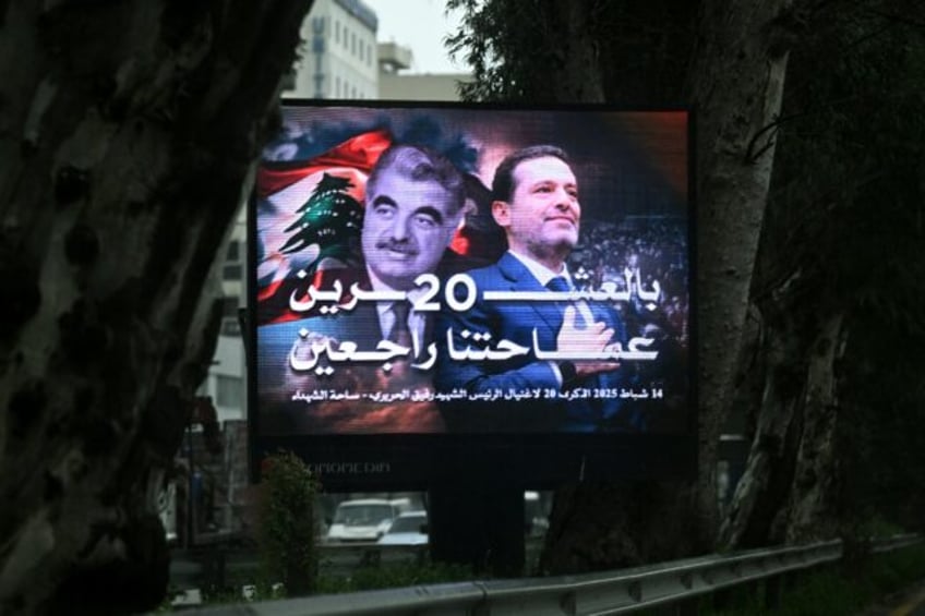 A giant billboard bears portraits of Lebanon's slain former prime minister Rafic Hariri (L